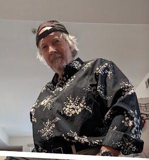 Joseph in a patterned shirt and cap