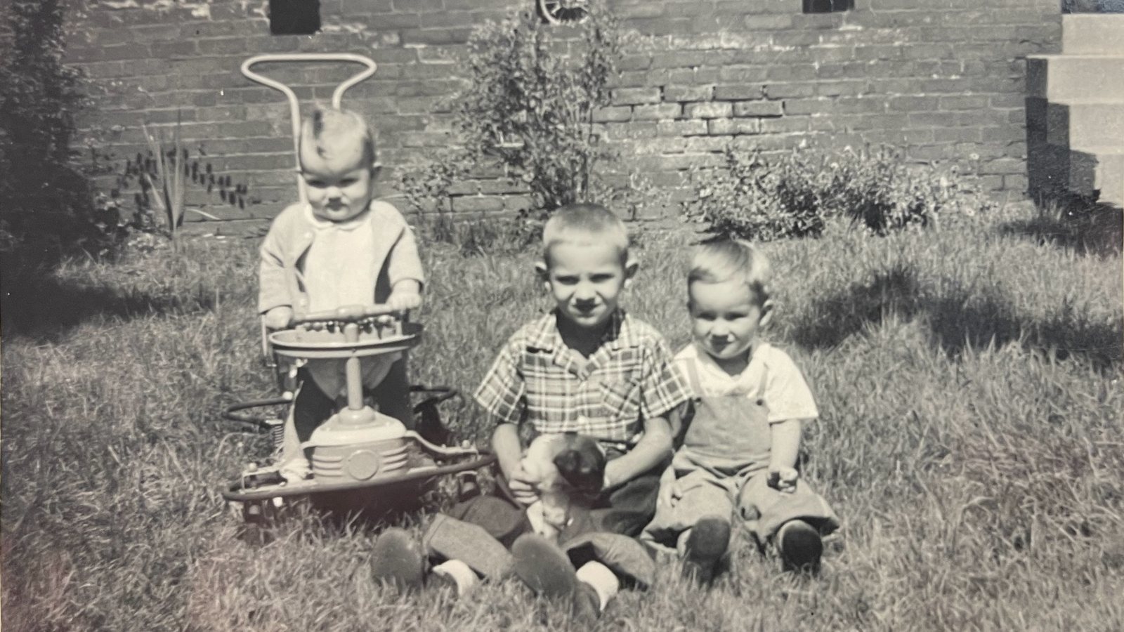 Joseph in a yard with his aunt Linda Lee and his uncle Mike